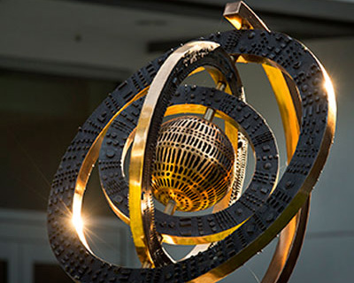 a brass globe statue part of the art on display in Freeman's GWBC.